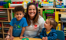 Child care worker smiles with children